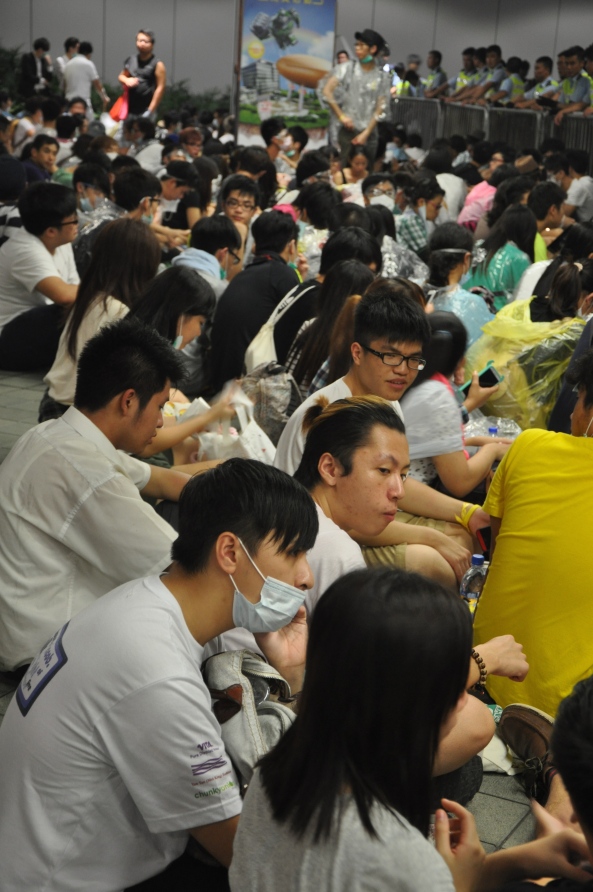 Students and citizens sit on Admiralty Bridge