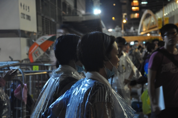 Protesters in raincoats